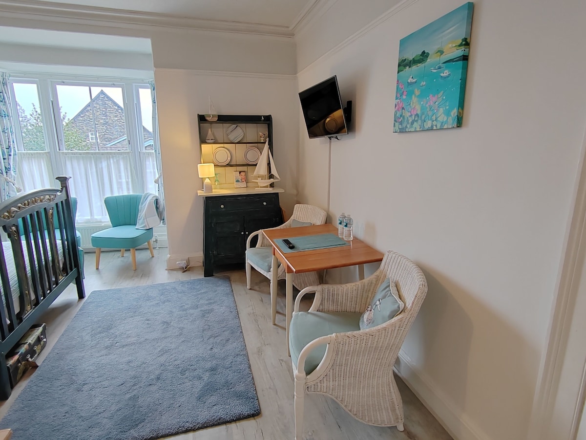 Sitting area with wooden table and cane chairs
