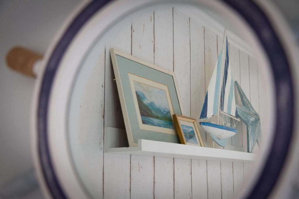 Porthole mirror reflecting nautical decor