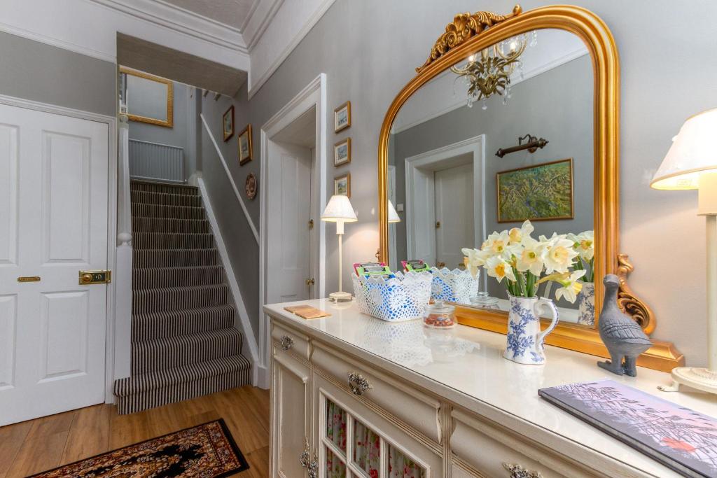 Dresser, mirror and staircase in a guest room