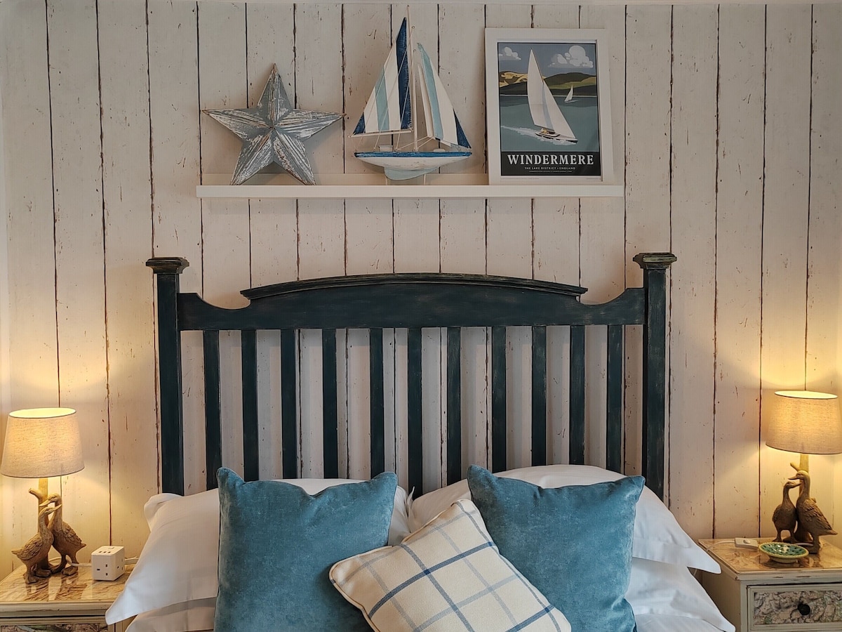 Nautical themed bedroom with dark headboard